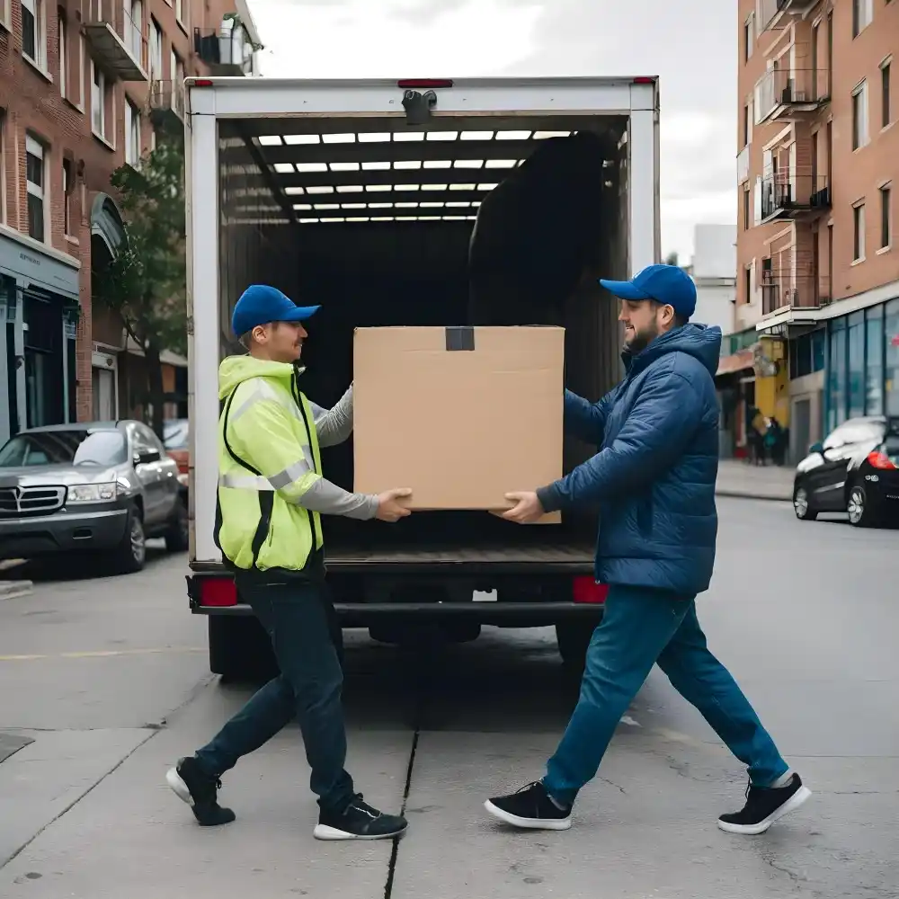 Long distance movers in New Zealand loading furniture onto moving truck safely